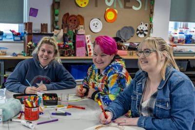 Three people working on art